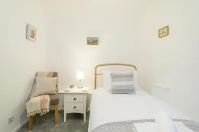 a bedroom with a bed and a desk with a chair at 1 King Street in Aldeburgh