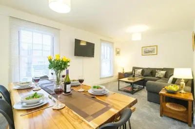 a living room with a table and a couch at 1 King Street in Aldeburgh
