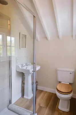 a bathroom with a toilet and a sink at 9 Whinlands in Thorpeness