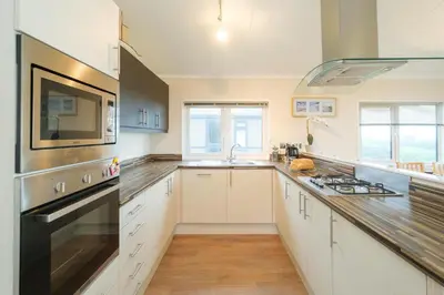 a kitchen with a sink and a stove top oven at San Remo in Sizewell