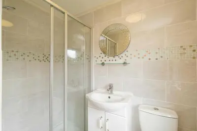 a bathroom with a shower and a sink and a toilet at San Remo in Sizewell