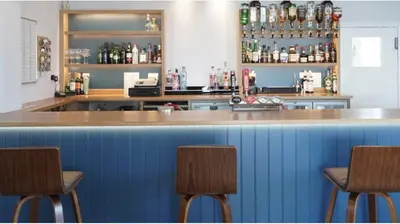 a bar with three chairs in front of it at San Remo in Sizewell