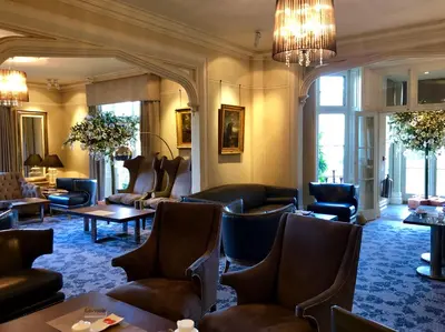 a waiting room with couches and chairs and tables at Talbooth House & Spa in Dedham