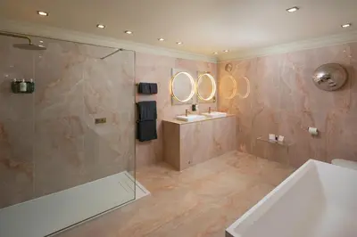 a bathroom with a shower and a tub and a sink at Talbooth House & Spa in Dedham