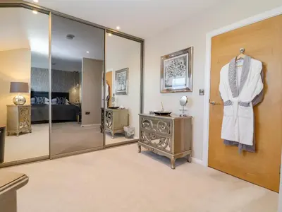 a dressing room with a robe hanging on a door at The Penthouse in Woodbridge