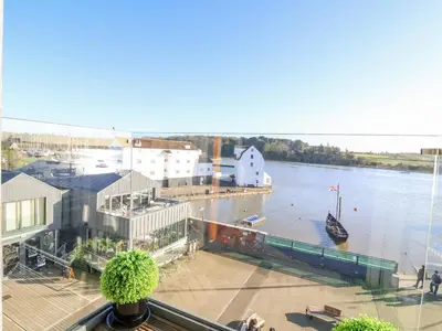 a view of a marina with a boat in the water at The Penthouse in Woodbridge