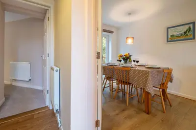 a dining room with a table and chairs at The Pines in Aldeburgh