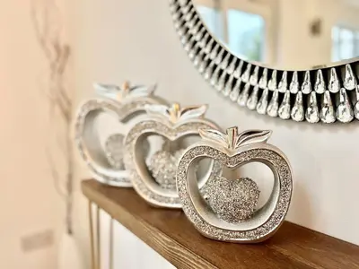 a row of silver heart bowls on a shelf with a mirror at Rest on Super-King Bed under The Starry Night in Chesterton