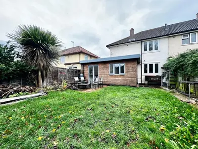 a yard with a house and a palm tree at Rest on Super-King Bed under The Starry Night in Chesterton