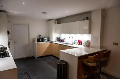 a kitchen with a sink and a counter top at Exquisite cozy house, close to Train Station and amenities in Harold Wood