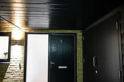 a black door in a room with a brick wall at Exquisite cozy house, close to Train Station and amenities in Harold Wood