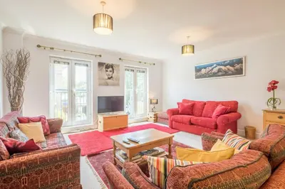 a living room with two couches and a tv at Charming & Spacious House With FREE PARKING in Chesterton