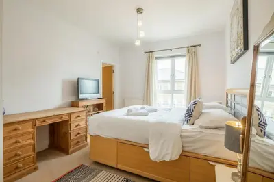 a bedroom with a bed with a desk and a tv at Charming & Spacious House With FREE PARKING in Chesterton