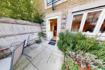 a patio with two benches in front of a house at Charming & Spacious House With FREE PARKING in Chesterton