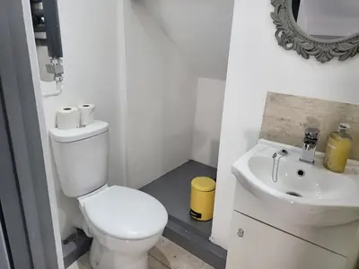 a white bathroom with a toilet and a sink at Vetrelax Southend Suites- Sleeps up to 5 - Free Wi-Fi - Contractors - Families- Free Parking- Long Term Stays in Southend-on-Sea