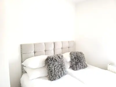 a white bed with two pillows on top of it at Vetrelax Southend Suites- Sleeps up to 5 - Free Wi-Fi - Contractors - Families- Free Parking- Long Term Stays in Southend-on-Sea