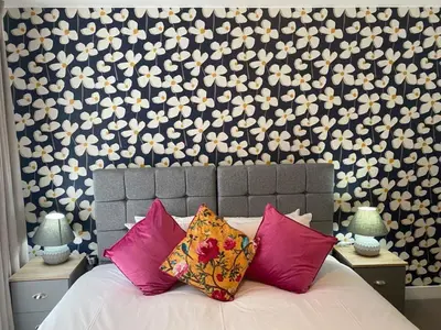 a bedroom with a bed with pink and white pillows at Exquisite & Contemporary 2 Bed Apartment w Parking 10 mins walk to Papworth, Addenbrookes hospitals & Bio Medical Campus in Trumpington