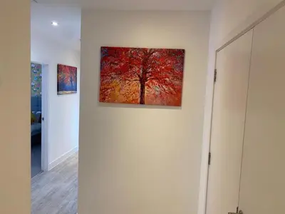 a painting of a tree on the wall of a room at Exquisite & Contemporary 2 Bed Apartment w Parking 10 mins walk to Papworth, Addenbrookes hospitals & Bio Medical Campus in Trumpington