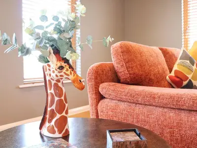 a giraffe statue sitting on a table in a living room at Woodbridge Penthouse in Woodbridge