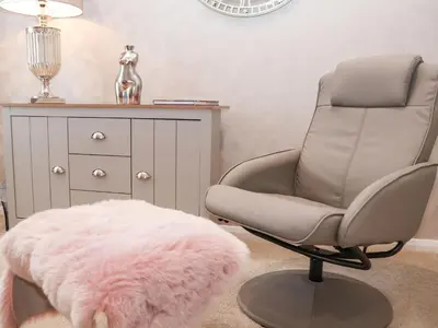 a chair with a pink rug next to a desk at Woodbridge Penthouse in Woodbridge