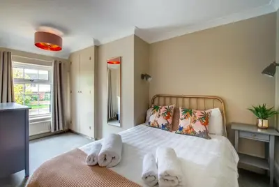 a bedroom with a bed with white towels on it at Belle Vue Cottage in Downham Market