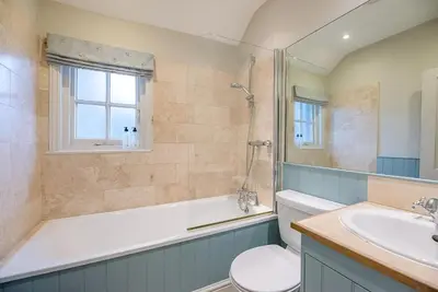 a bathroom with a tub and a toilet and a sink at 18 Hartington, Aldeburgh in Aldeburgh