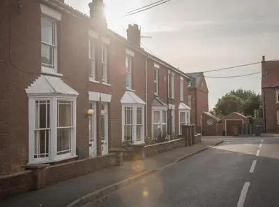 an empty street with a row of brick houses at 18 Hartington, Aldeburgh in Aldeburgh