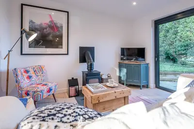 a living room with a couch and a coffee table at Little Bramble, Orford in Orford