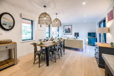 a kitchen and dining room with a table and chairs at Little Bramble, Orford in Orford