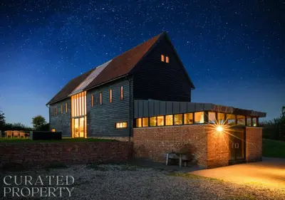 a barn at night with a starry sky at Grand Suffolk Barn Conversion in Chelsworth