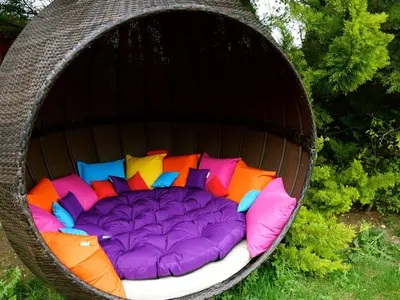 a colorful pet bed in a hanging basket at Deluxe 2 Bed Versace Bungalow Hot Tub, Sky TV, Cinema Screen Saffron Walden in Saffron Walden