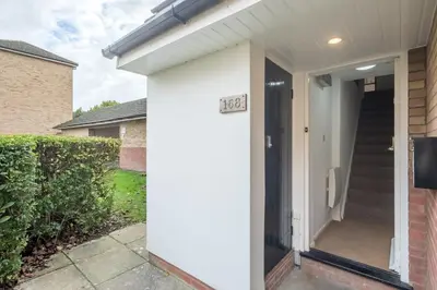 a front door of a house with a sign on it at Modern & Private - Free Parking in Cherry Hinton