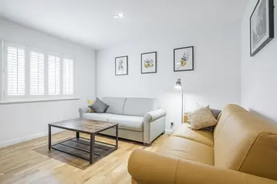 a living room with a couch and a table at Modern & Private - Free Parking in Cherry Hinton