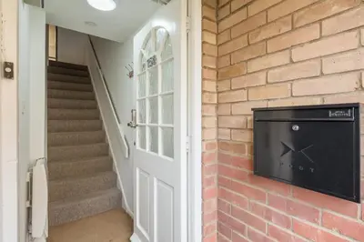 a brick wall with a tv on a wall at Modern & Private - Free Parking in Cherry Hinton