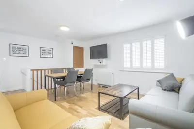 a living room with a couch and a table at Modern & Private - Free Parking in Cherry Hinton