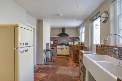 a large kitchen with a sink and a refrigerator at 2 Bed in Eye oc-4lamb in Eye