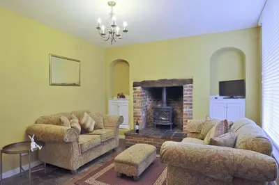 a living room with two couches and a fireplace at 2 Bed in Eye oc-4lamb in Eye