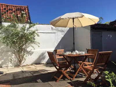 a table and chairs with an umbrella on a patio at 2 Bed in Eye oc-4lamb in Eye