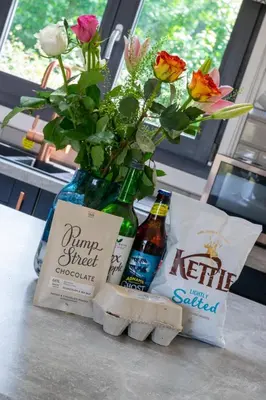 a vase with flowers in it sitting on a table at 2 Bed in Stradbroke oc-wopl in Stradbroke