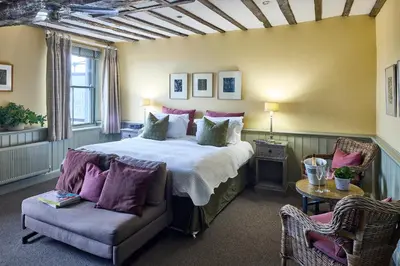 a bedroom with a large bed and a couch at The Mistley Thorn in Mistley