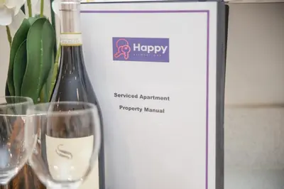 a picture of a bottle of wine next to two glasses at Stunning 2-Bed Apartment in Stevenage, Sleeps 5 with free Private Parking in Stevenage