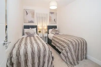 two beds in a room with white walls at Stunning 2-Bed Apartment in Stevenage, Sleeps 5 with free Private Parking in Stevenage