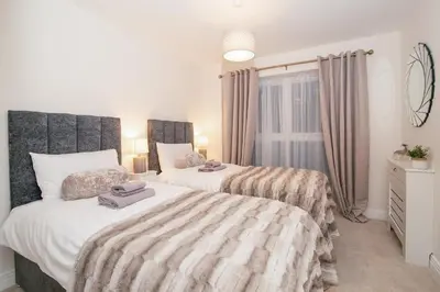 a bedroom with two beds and a window at Stunning 2-Bed Apartment in Stevenage, Sleeps 5 with free Private Parking in Stevenage