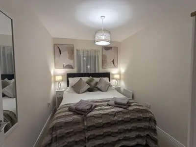 a bedroom with a bed with two towels on it at Stunning 2-Bed Apartment in Stevenage, Sleeps 5 with free Private Parking in Stevenage