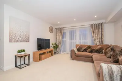a living room with a couch and a tv at Stunning 2-Bed Apartment in Stevenage, Sleeps 5 with free Private Parking in Stevenage