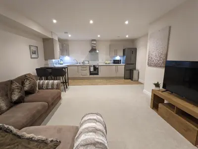 a large living room with a couch and a tv at Stunning 2-Bed Apartment in Stevenage, Sleeps 5 with free Private Parking in Stevenage