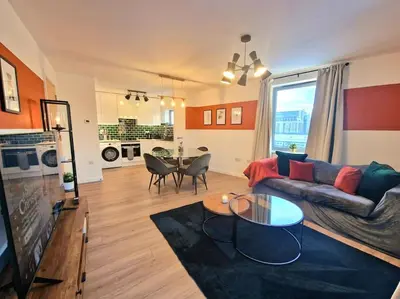 a living room with a couch and a table at Luxury Station Apartment in Cambridge