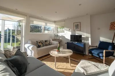 a living room with a couch and a table at 9 Uplands in Thorpeness