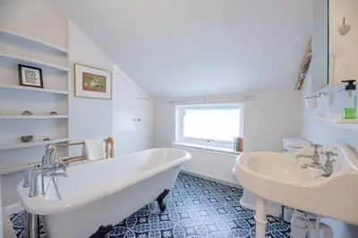 a white bathroom with two sinks and a tub at Jenny Rose Cottage, Wickham Market in Woodbridge