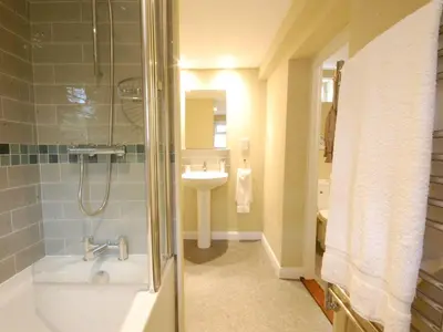 a bathroom with a shower and a sink at Crabbe Corner in Aldeburgh